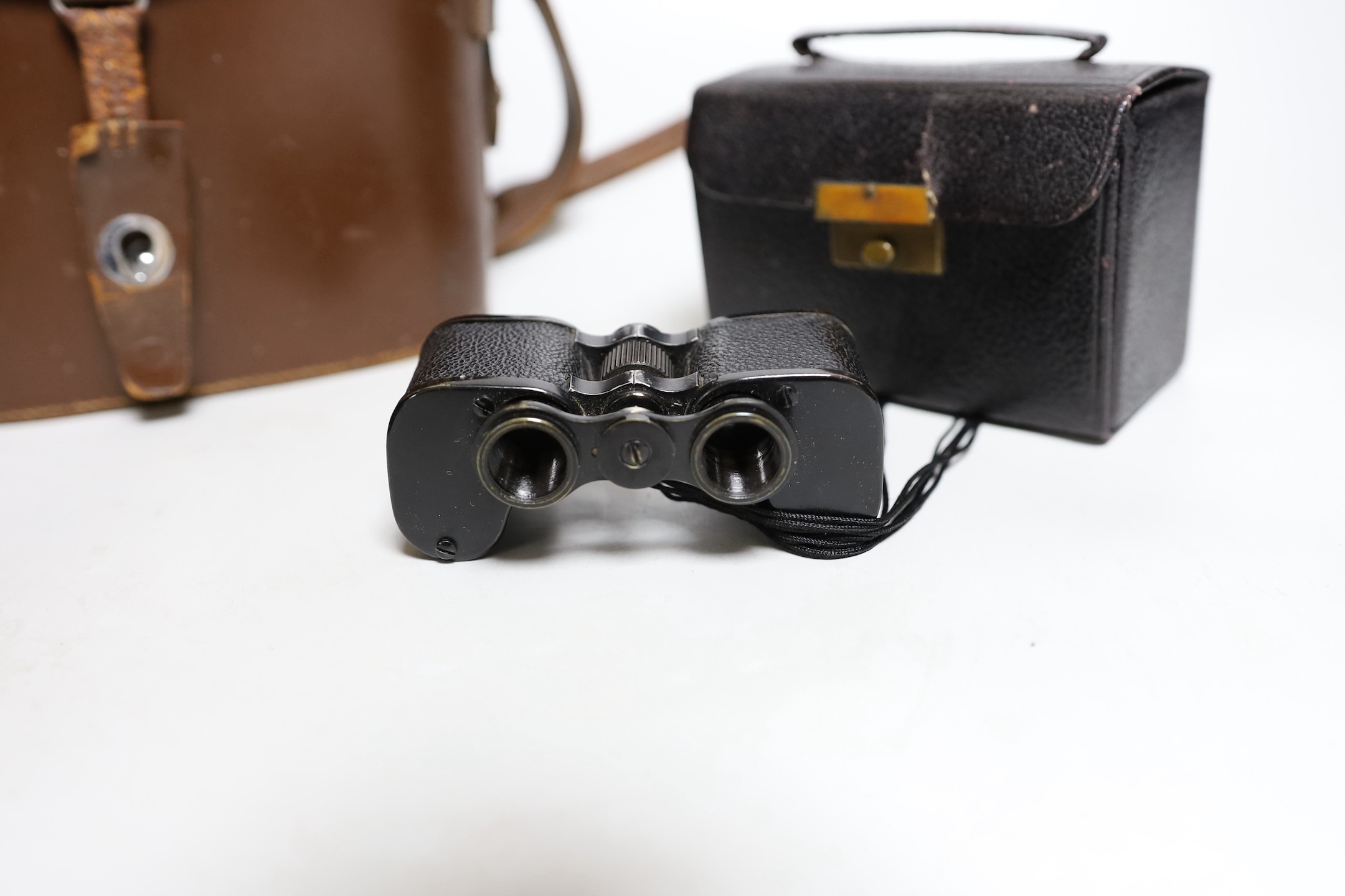 A cased set of Ross binoculars and a smaller cased set for racing
